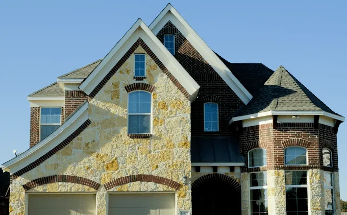 Architectural shingle roof on a stone and brick North Texas home